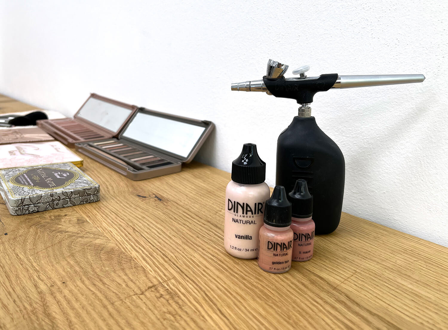 An airbrush with makeup brushes.