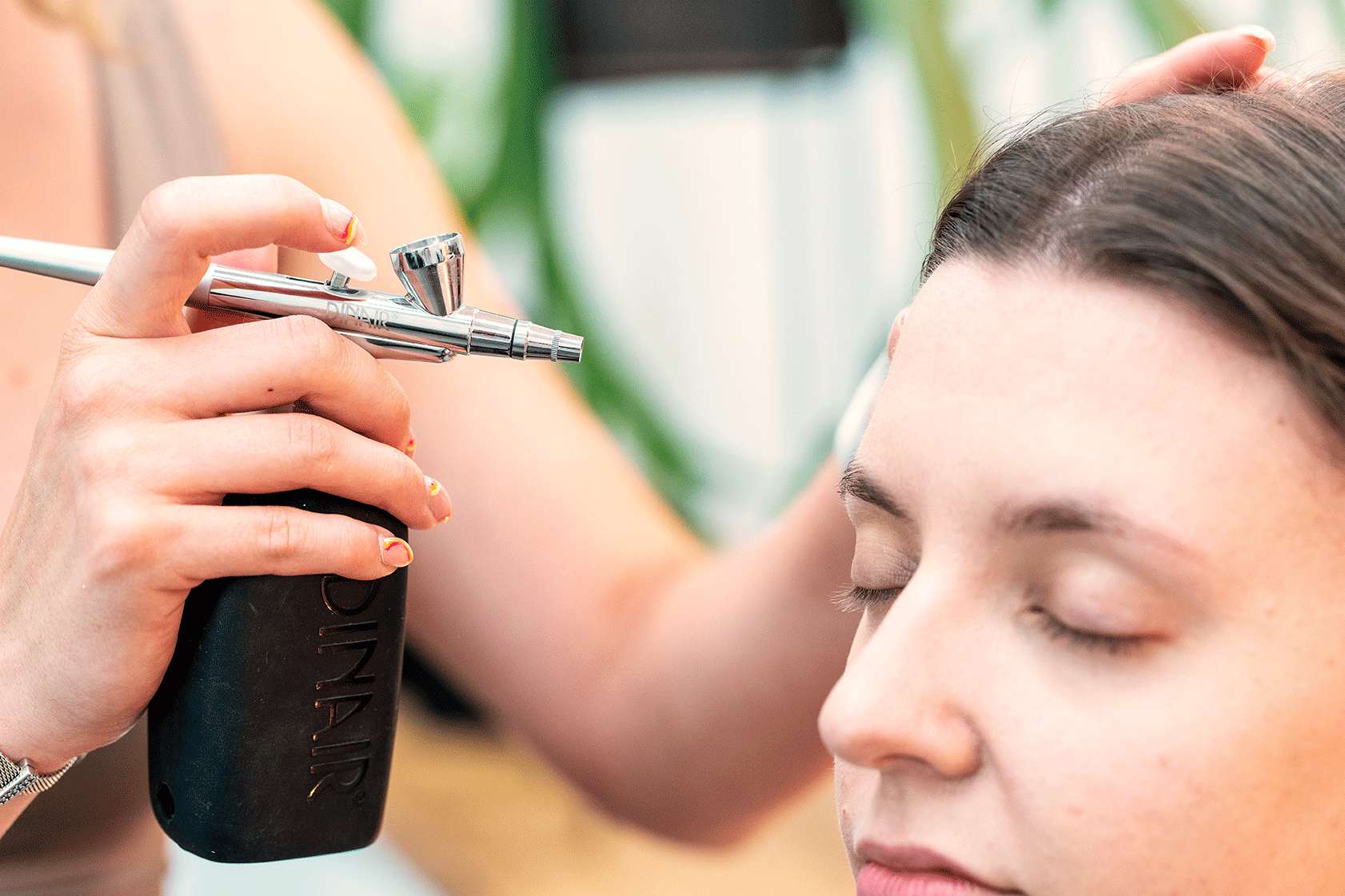 An airbrush being applied on a face.